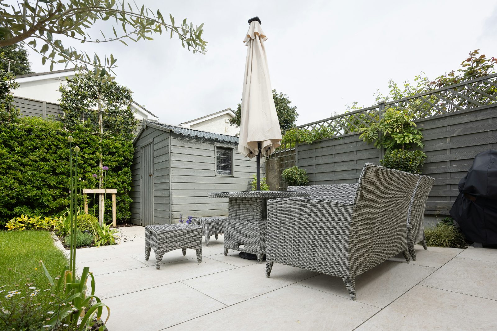 Backyard concrete patio with seating in Colorado Springs