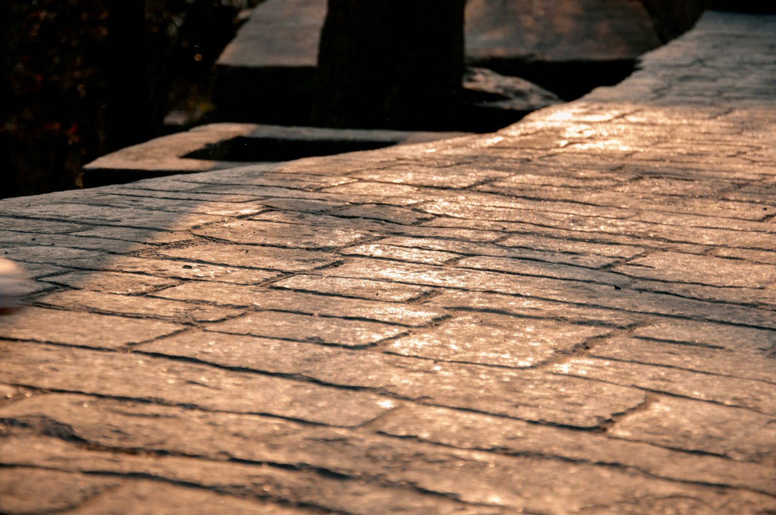 Stamped concrete with a stone pattern in warm evening light