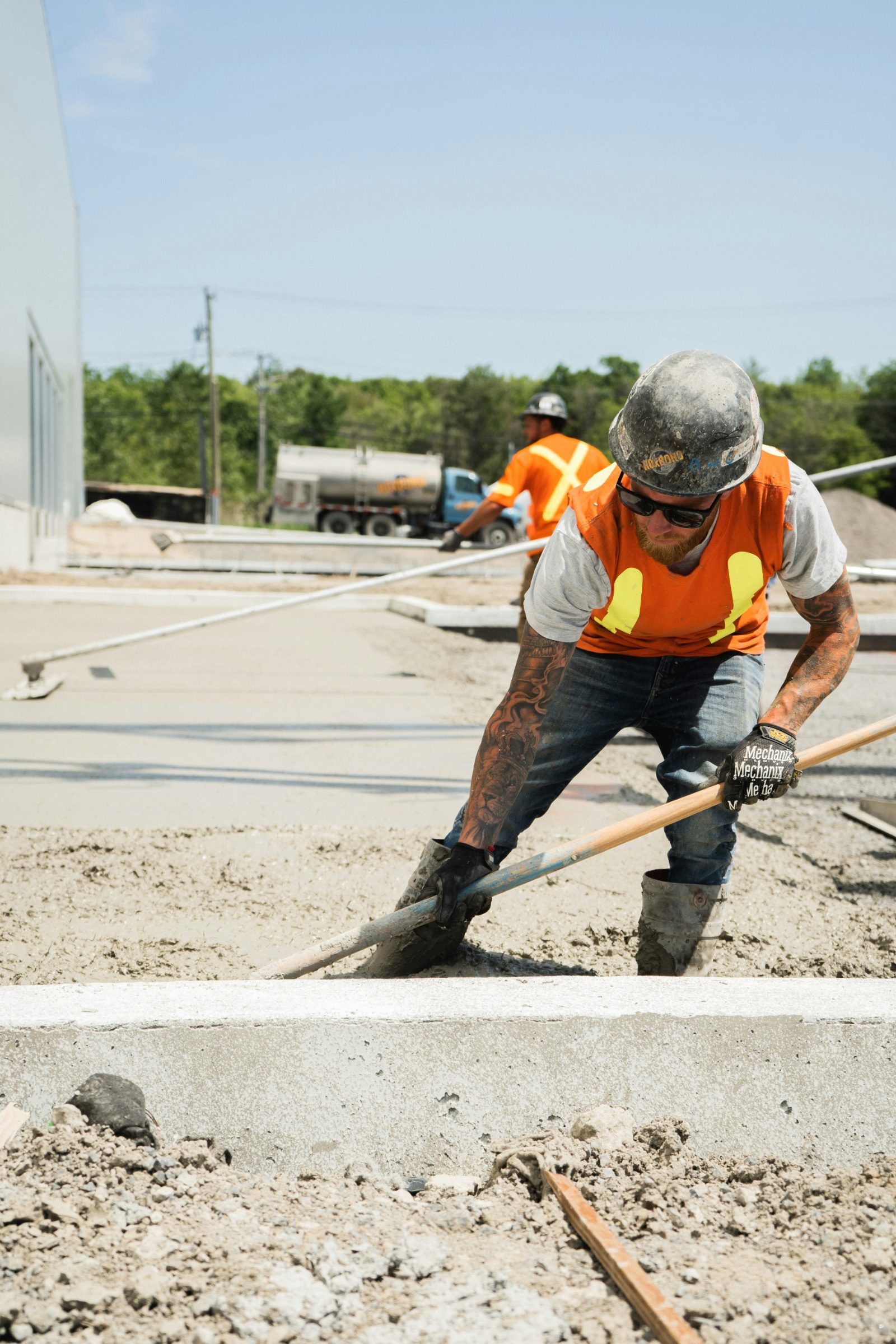 Concrete crew finishing a freshly poured slab